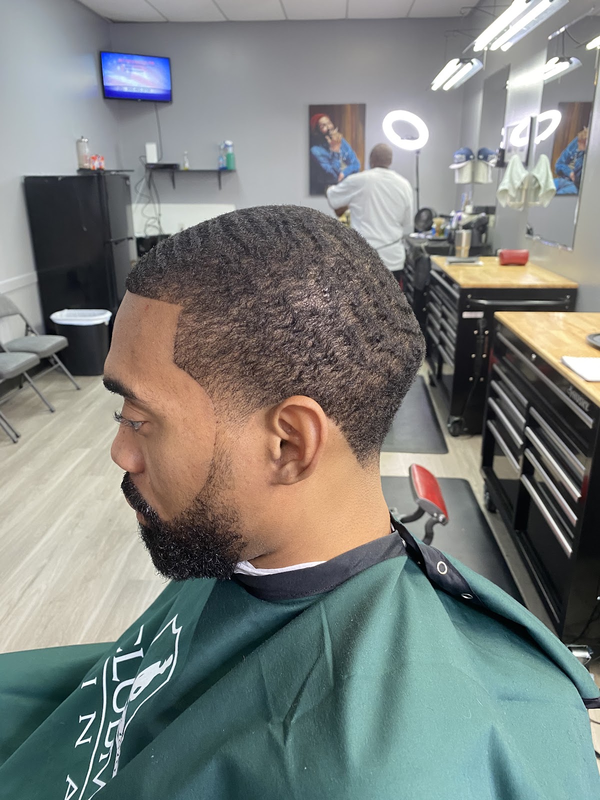Barber finishing a cut at Hwy 6 Barber Shop